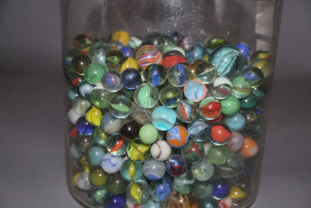 A glass jar and cover containing Victorian and later coloured marbles, height 26.5cm